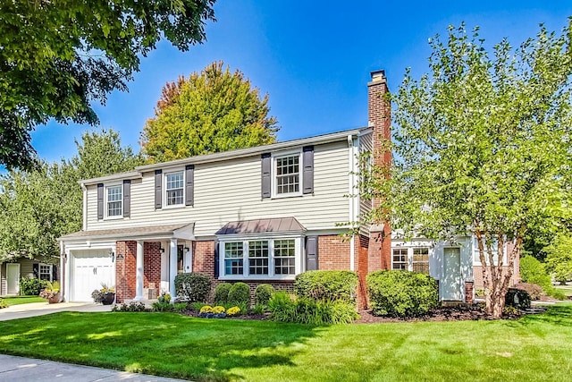 view of front of home with a front yard and a garage