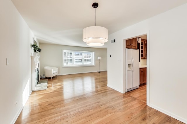 unfurnished dining area featuring light hardwood / wood-style floors