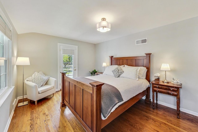 bedroom with hardwood / wood-style flooring and access to exterior