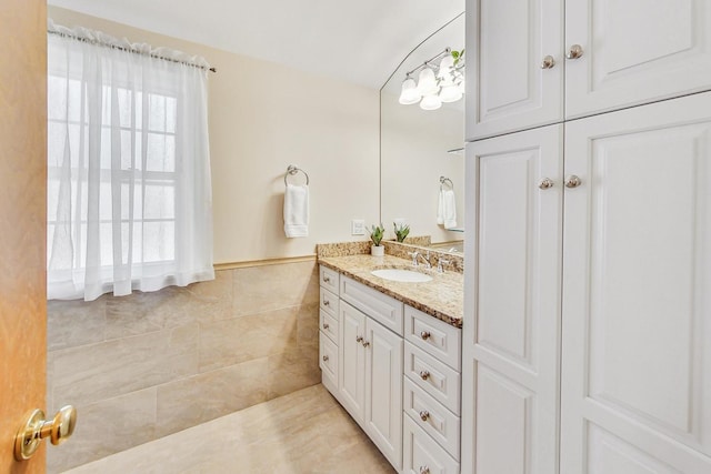 bathroom featuring tile walls and vanity