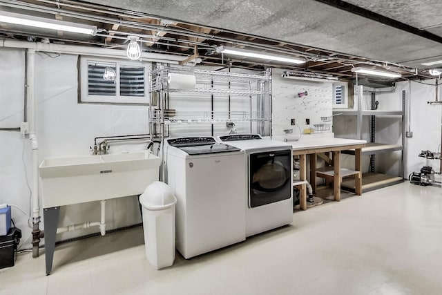 laundry room featuring washer and dryer and a workshop area