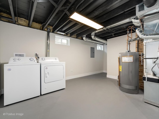 clothes washing area featuring electric panel, gas water heater, a healthy amount of sunlight, and washing machine and clothes dryer