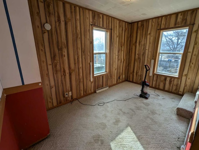 unfurnished room featuring light colored carpet and a baseboard heating unit