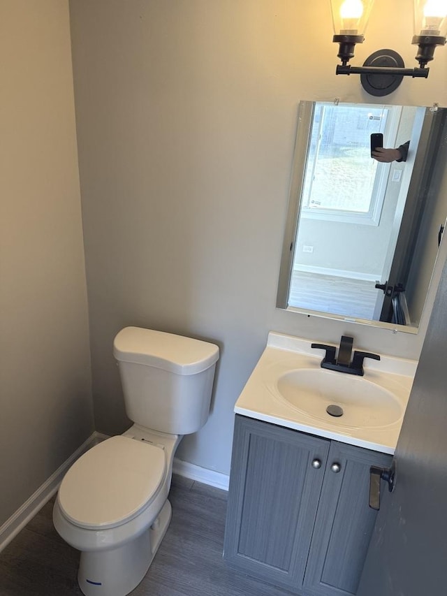 bathroom featuring hardwood / wood-style floors, vanity, and toilet