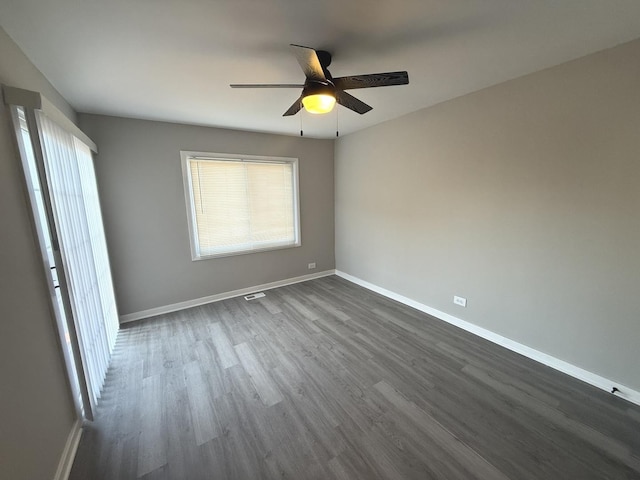 spare room with ceiling fan and dark wood-type flooring