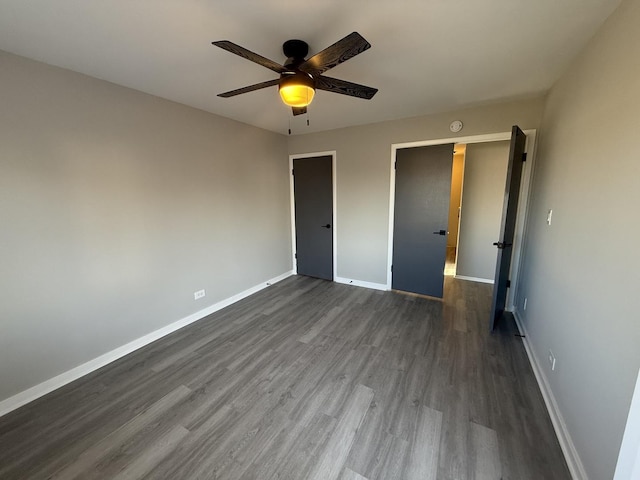 unfurnished bedroom featuring ceiling fan, dark hardwood / wood-style flooring, and a closet