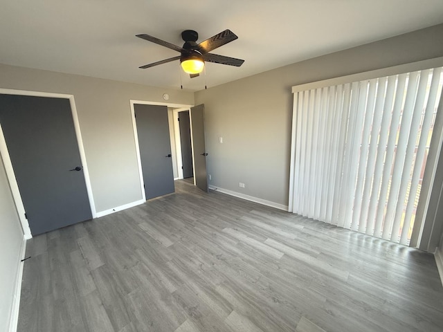 unfurnished bedroom featuring light wood-type flooring, a closet, and ceiling fan