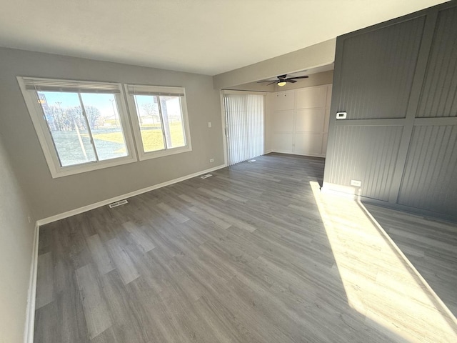 unfurnished room featuring hardwood / wood-style flooring and ceiling fan