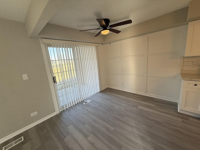 interior space featuring ceiling fan and dark wood-type flooring