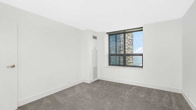 empty room featuring dark colored carpet