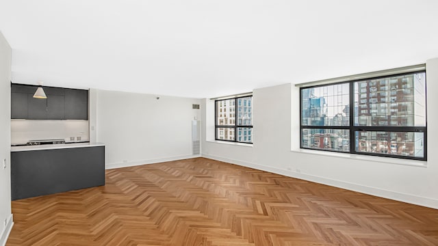 unfurnished living room featuring light parquet floors