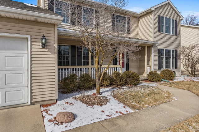 view of front of house featuring a porch and an attached garage