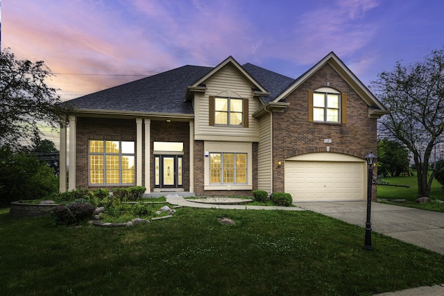 view of front of property featuring a yard and a garage