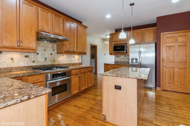 foyer featuring light hardwood / wood-style flooring, a high ceiling, and an inviting chandelier