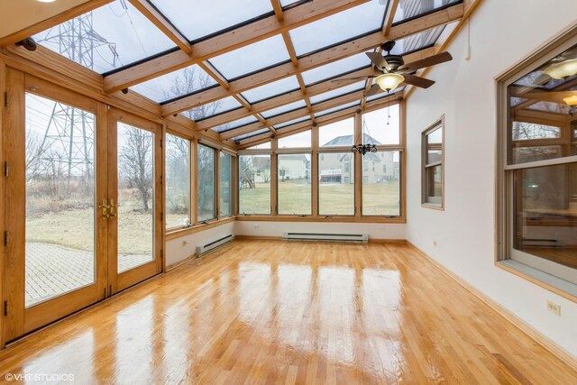 unfurnished living room with ceiling fan with notable chandelier, a healthy amount of sunlight, ornate columns, and a brick fireplace