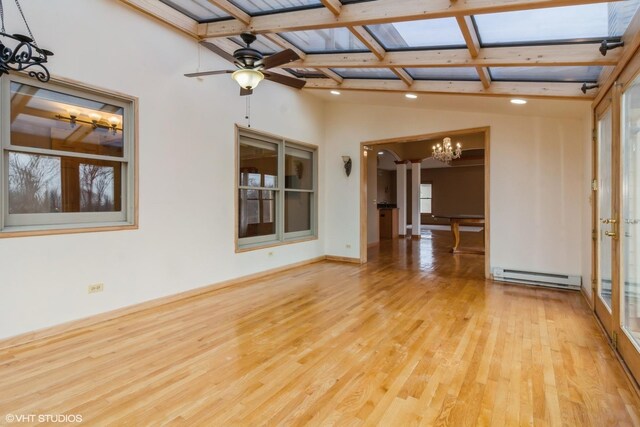 unfurnished living room featuring ceiling fan, a fireplace, a high ceiling, and light hardwood / wood-style flooring