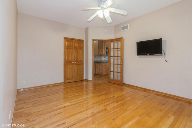 kitchen with decorative light fixtures, decorative backsplash, light wood-type flooring, appliances with stainless steel finishes, and stone countertops