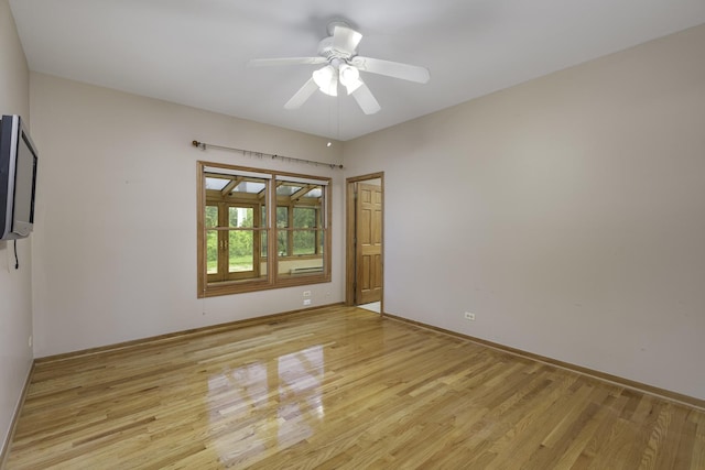 spare room featuring light hardwood / wood-style floors and ceiling fan