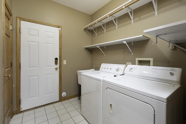 laundry area featuring washer and dryer and light tile patterned floors