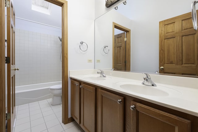 full bathroom with tile patterned flooring, vanity, toilet, and tiled shower / bath