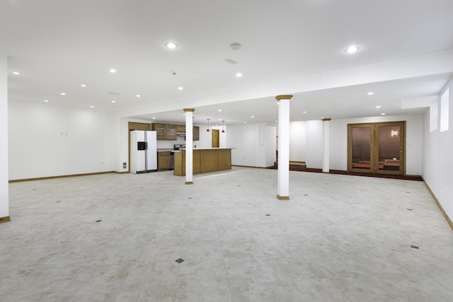 basement with white refrigerator with ice dispenser