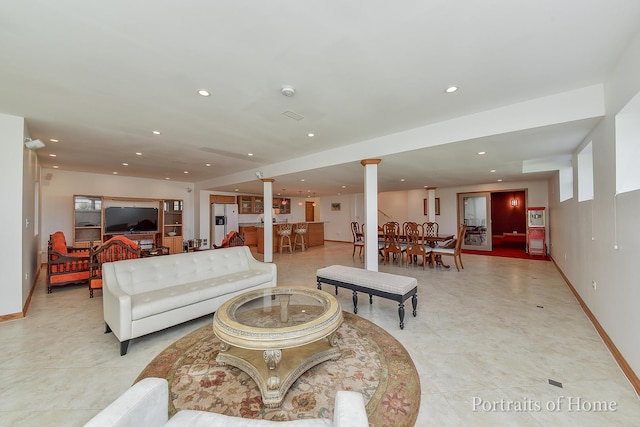 living room featuring decorative columns