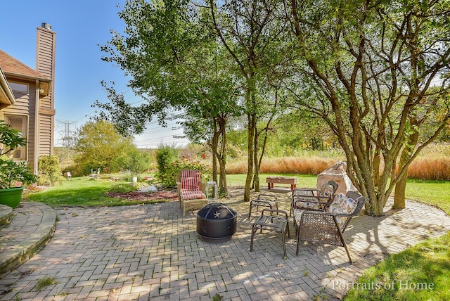 view of patio with a fire pit