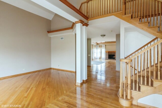 entryway featuring a towering ceiling and decorative columns