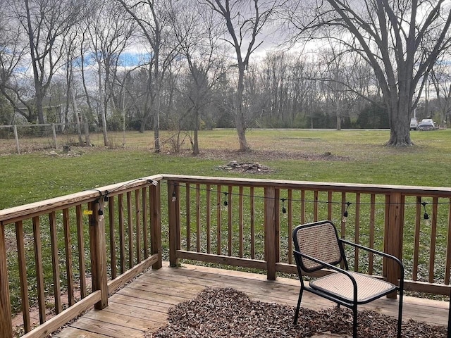 wooden terrace with a lawn