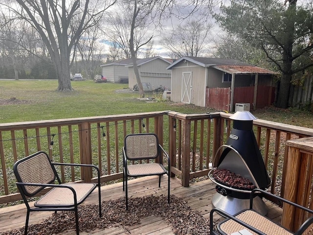 deck featuring a storage shed and a yard