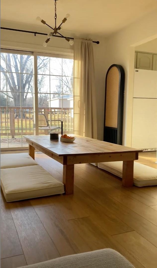 unfurnished dining area featuring hardwood / wood-style floors and a chandelier