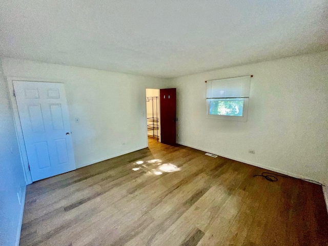 spare room with light hardwood / wood-style floors