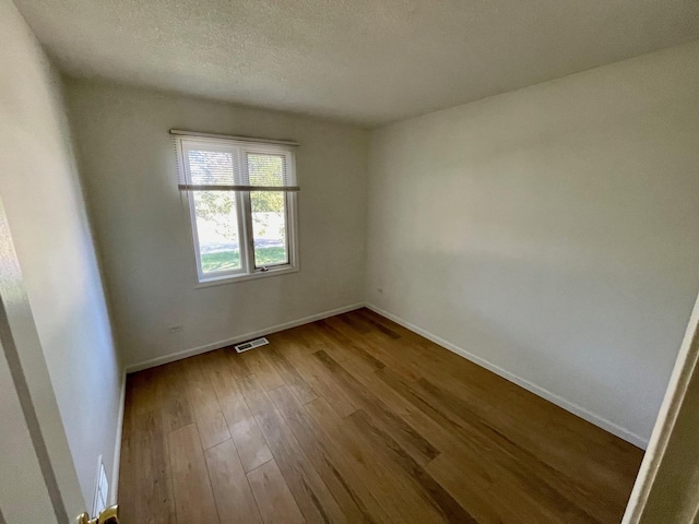 unfurnished room featuring hardwood / wood-style flooring