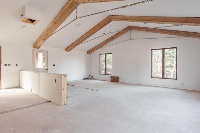 bonus room featuring plenty of natural light, beam ceiling, and high vaulted ceiling