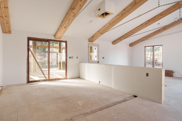 unfurnished room featuring lofted ceiling with beams