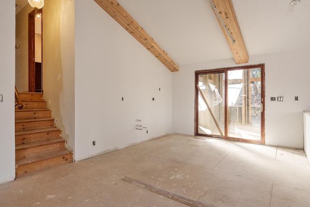 unfurnished living room with lofted ceiling with beams