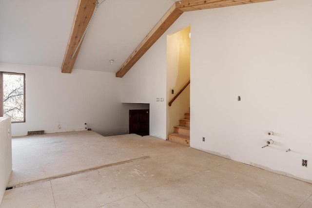 unfurnished living room featuring beam ceiling and high vaulted ceiling