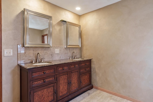 bathroom with backsplash, vanity, and hardwood / wood-style flooring