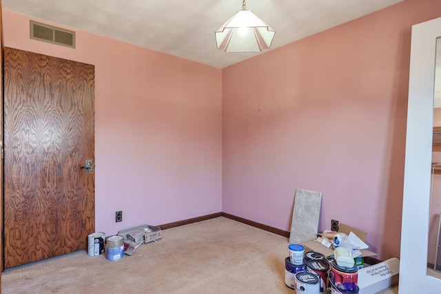 unfurnished room featuring light carpet