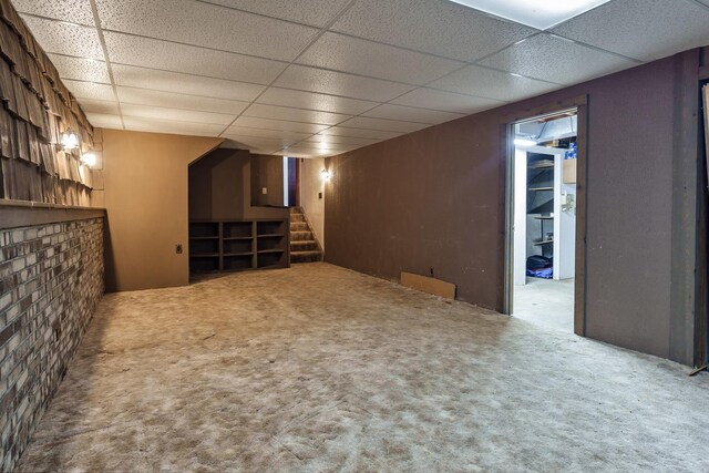 basement with a drop ceiling and carpet floors