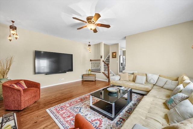 living room with ceiling fan and hardwood / wood-style flooring