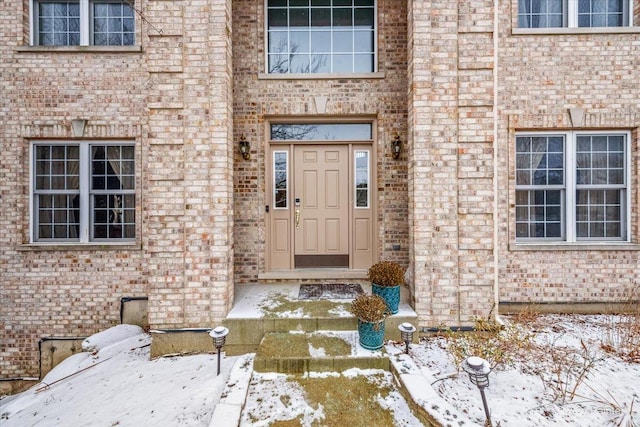 view of snow covered property entrance