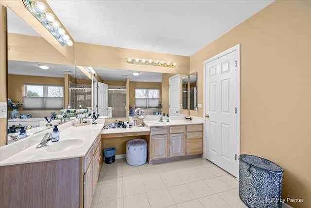 bathroom with tile patterned flooring, vanity, and an enclosed shower