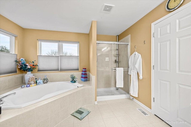 bathroom featuring tile patterned floors and plus walk in shower