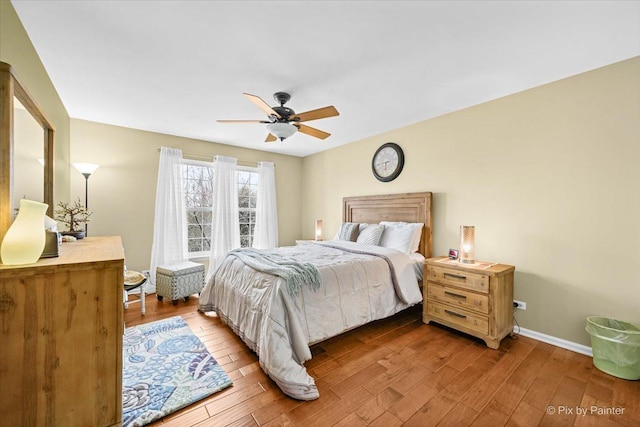 bedroom with light hardwood / wood-style flooring and ceiling fan