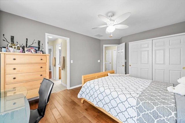 bedroom featuring ceiling fan, wood-type flooring, and a closet