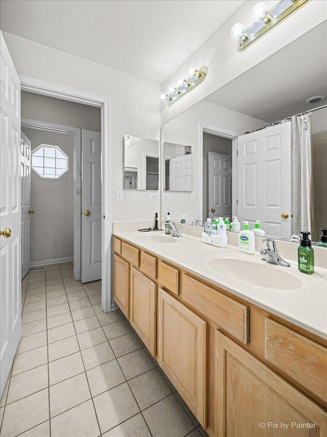 bathroom with tile patterned floors and vanity