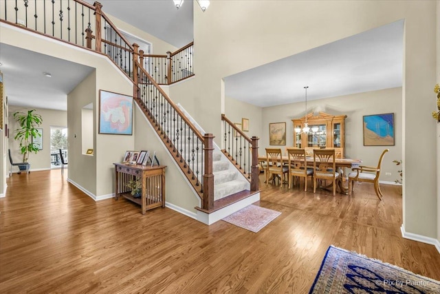 interior space featuring an inviting chandelier and light wood-type flooring