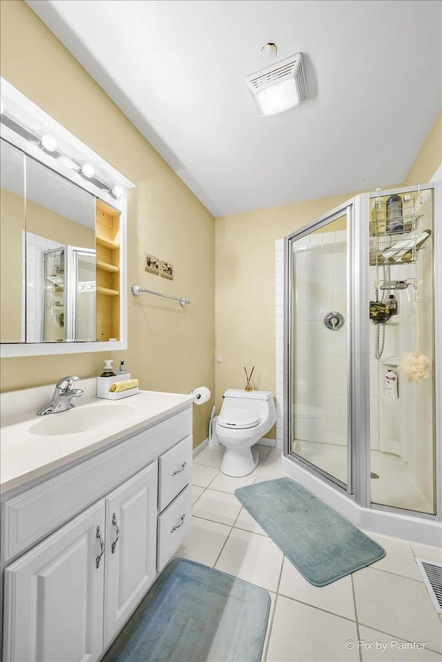 bathroom with tile patterned floors, lofted ceiling, toilet, a shower with door, and vanity