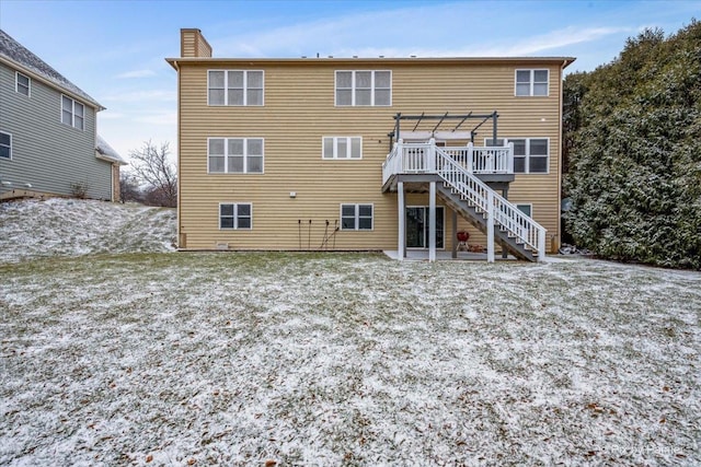 rear view of house with a pergola and a wooden deck